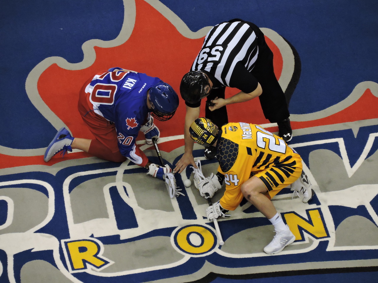 Bradley Kri and Jordan MacIntosh face-off as the Toronto Rock host the Georgia Swarm on February 17, 2017. (Photo credit: Anna Taylor)