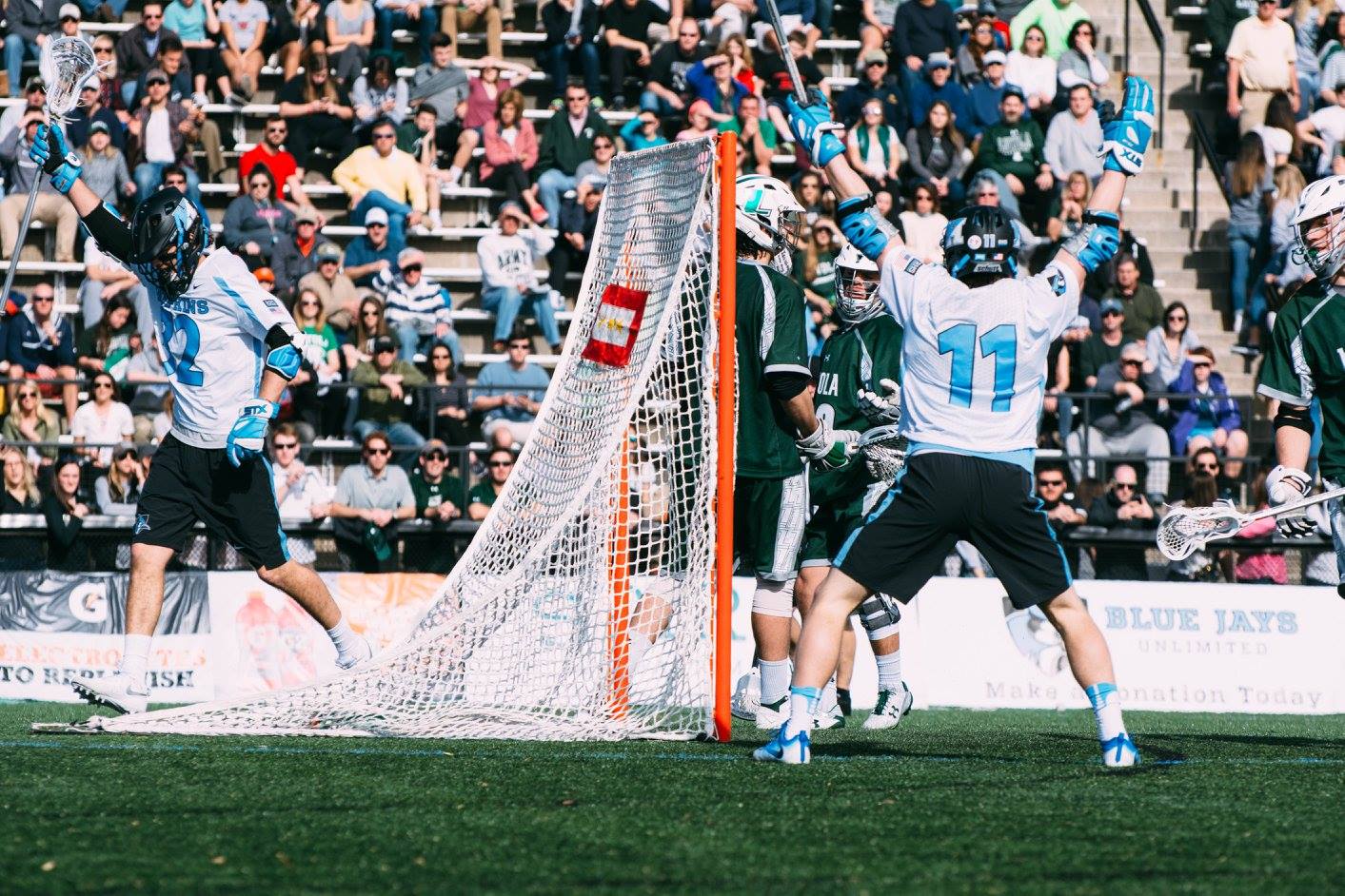 Shack Stanwick and Kieran Eissler of the Johns Hopkins Blue Jays react to a goal. (Photo credit: Kate McEvilly Photography)