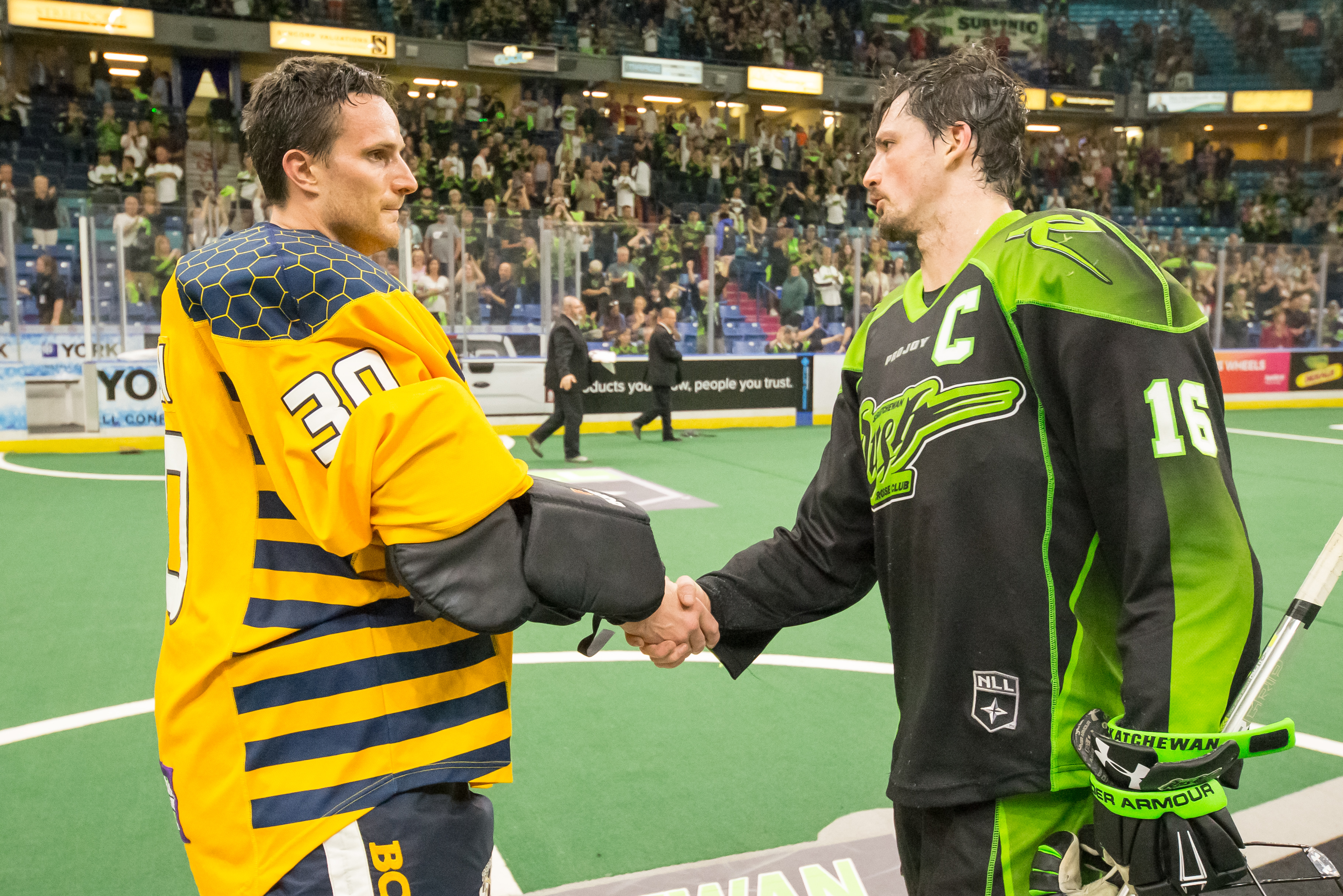 Mike Poulin of the Georgia Swarm shakes hands with captain Chris Corbeil of the Saskatchewan Rush. (Photo by Josh Schaefer/GetMyPhoto.ca)