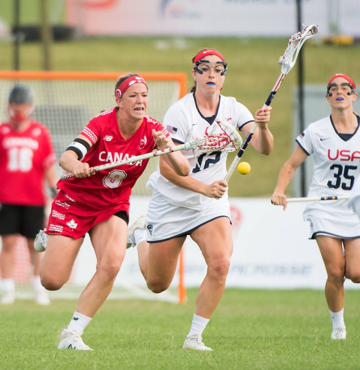 Canada's Katie Guy fights for possession with USA's Kayla Treanor at the 2017 FIL Rathbones Women's Lacrosse World Cup at Surrey Sports Park, Guilford, Surrey, UK, 15th July 2017. (Photo credit: Ady Kerry)