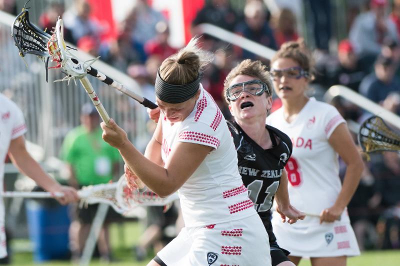 New Zealand's Jess Page tries to disposses Canada's Kay Morissette at the 2017 FIL Rathbones Women's Lacrosse World Cup at Surrey Sports Park, Guilford, Surrey, UK, 15th July 2017 (Credit Ady Kerry).