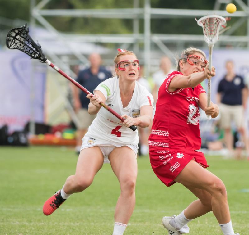 Taylor Gait scores for Canada while under pressure from Charlotte Lytollis at the 2017 FIL Rathbones Women's Lacrosse World Cup at Surrey Sports Park, Guilford, Surrey, UK, 15th July 2017 (Credit Ady Kerry).