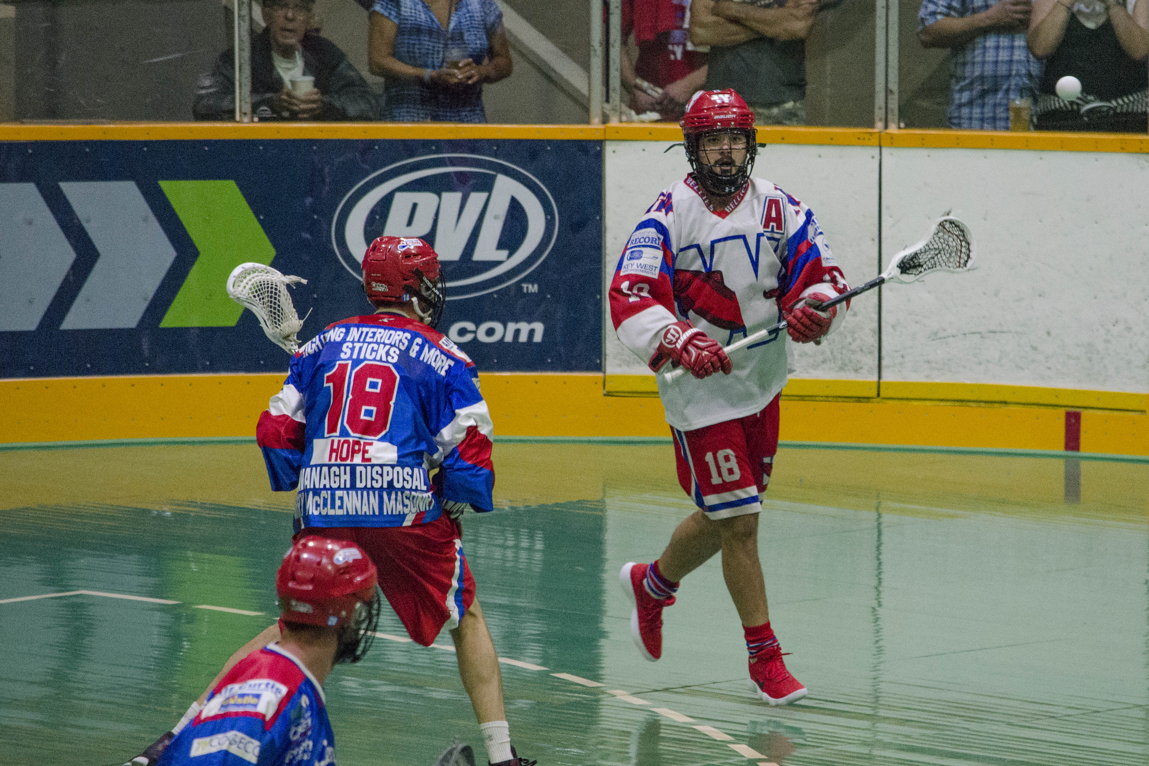 Logan Schuss of the New Westminster Salmonbellies is guarded by Robert Hope of the Peterborough Lakers during the 2017 Mann Cup. (Photo credit: Kendall Taylor)