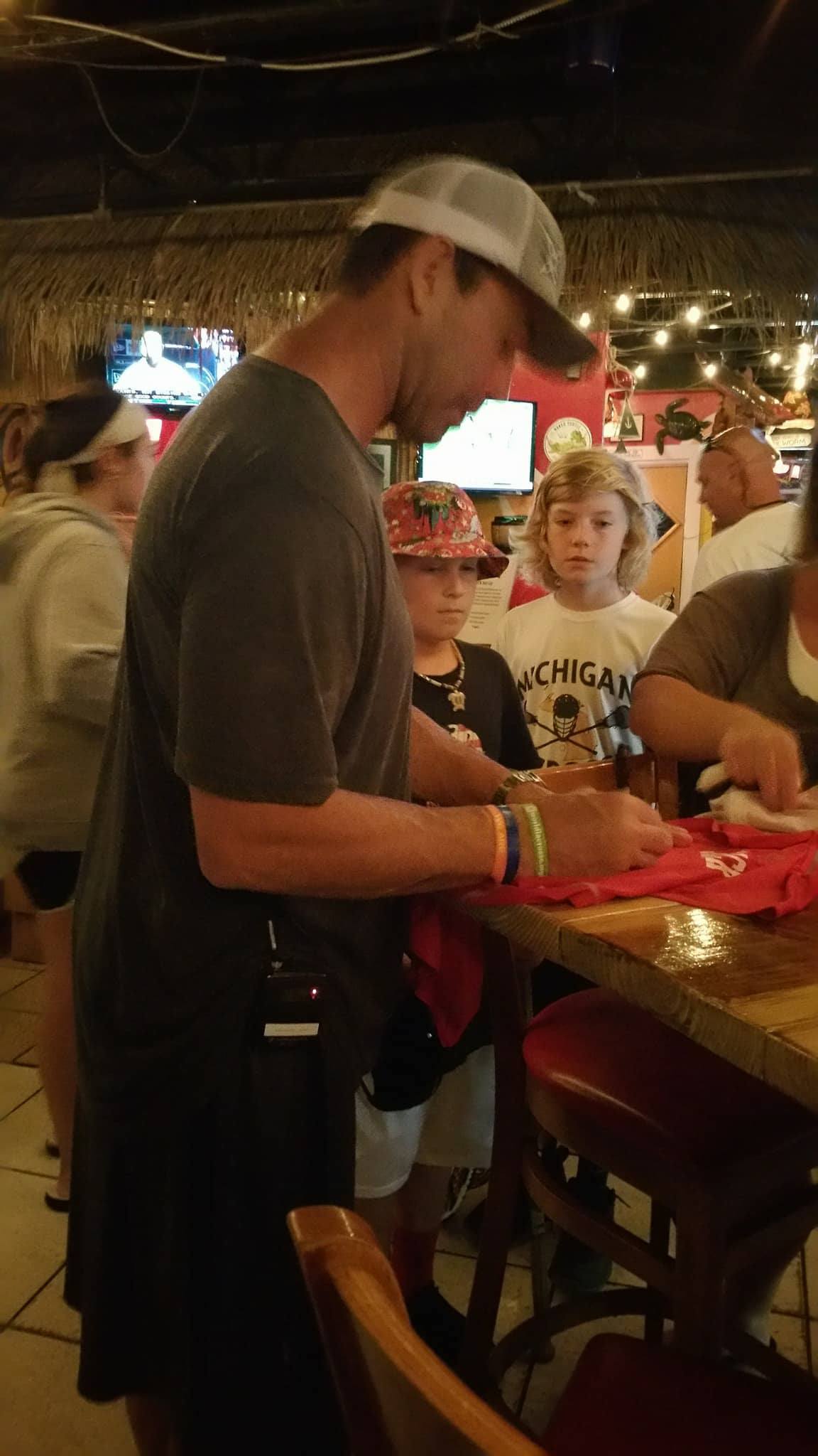 Casey Powell signs autographs at his World Lacrosse Foundation's Beach Festival 2017. (Photo credit: Andrew Baker)